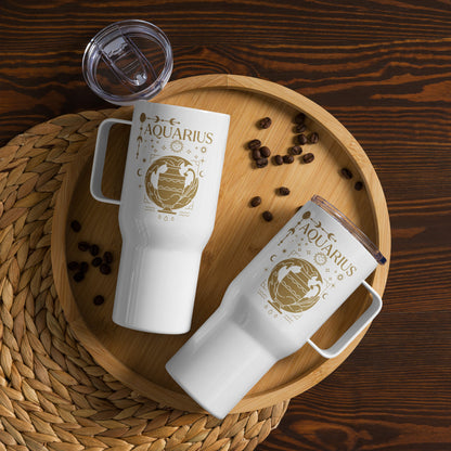 White travel mug with handle, featuring an Aquarius-themed design in brown tones. The design includes a stylized water-bearer symbol with celestial elements like stars, moons, and planetary symbols. The word 'Aquarius' is prominently displayed at the top, showcasing an astrology-inspired aesthetic.