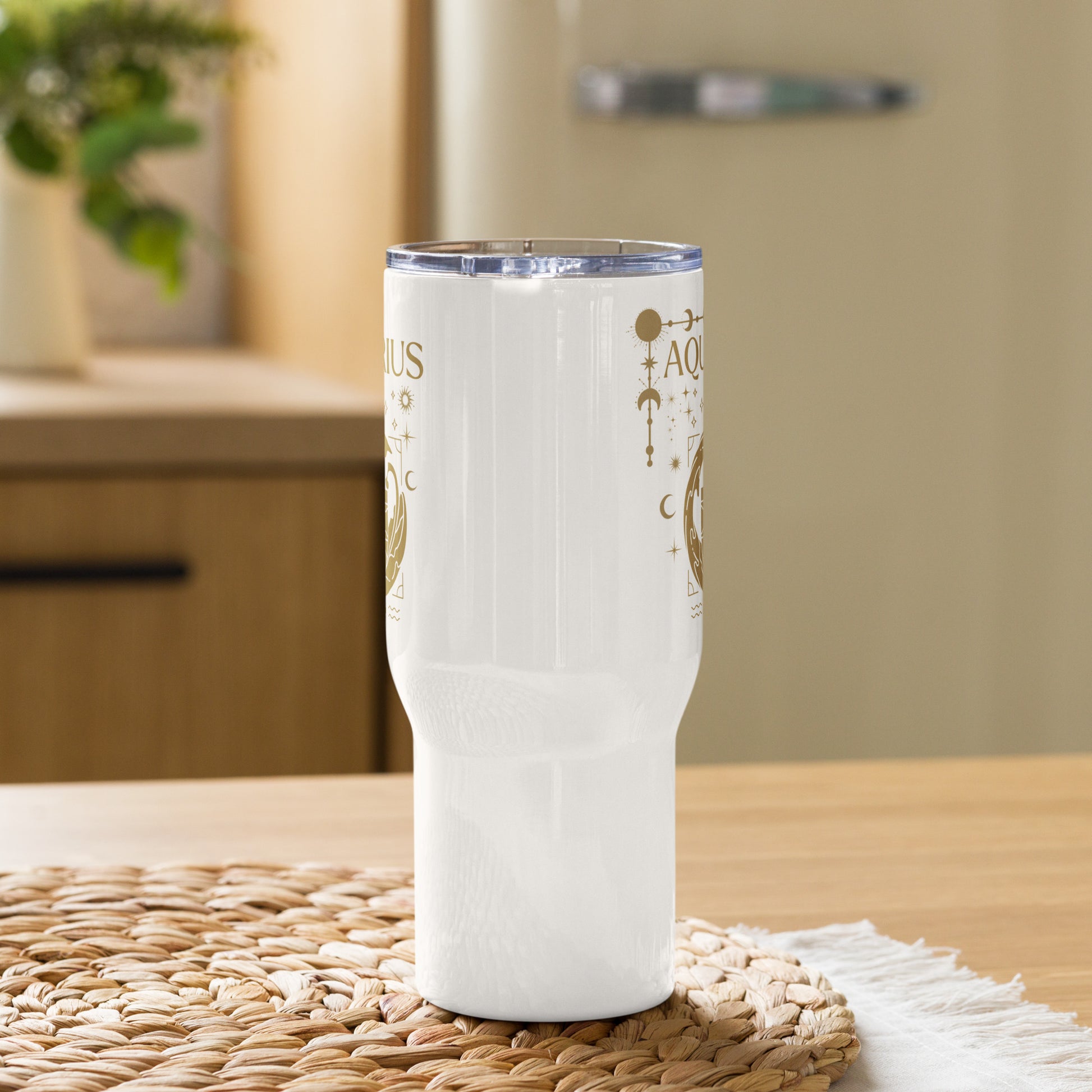 White travel mug with handle, featuring an Aquarius-themed design in brown tones. The design includes a stylized water-bearer symbol with celestial elements like stars, moons, and planetary symbols. The word 'Aquarius' is prominently displayed at the top, showcasing an astrology-inspired aesthetic.