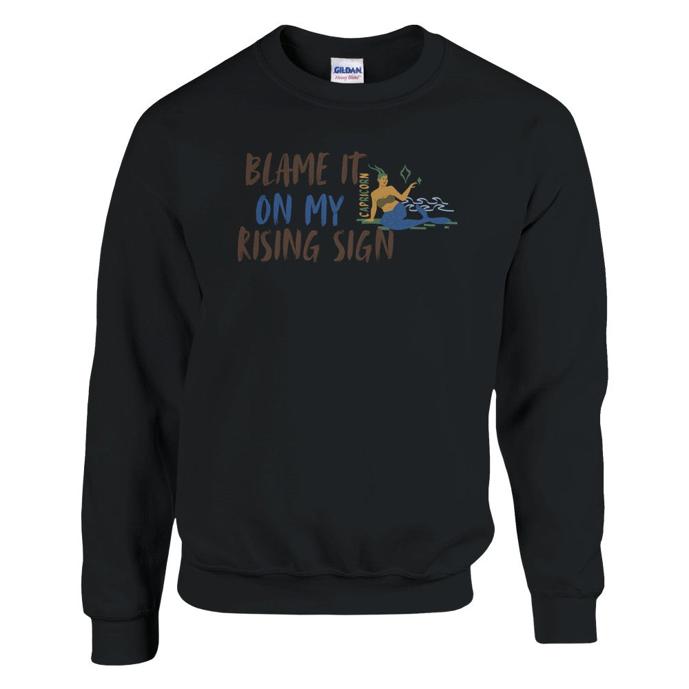 Front of black Capricorn-themed sweatshirt with 'Blame It On My Rising Sign' text and illustration of Capricorn zodiac symbol.