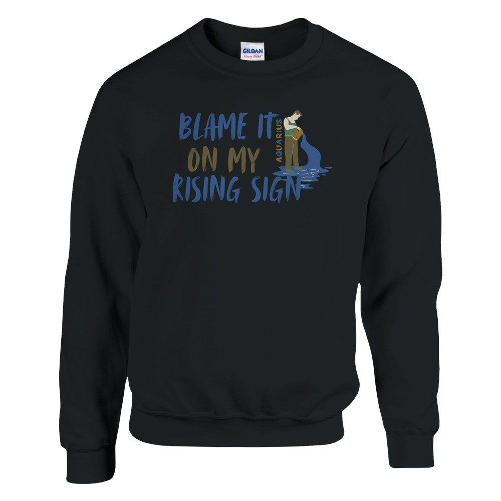 Black Aquarius sweatshirt with 'Blame It On My Rising Sign' text and colorful Aquarius water-bearer illustration in blue and brown tones.