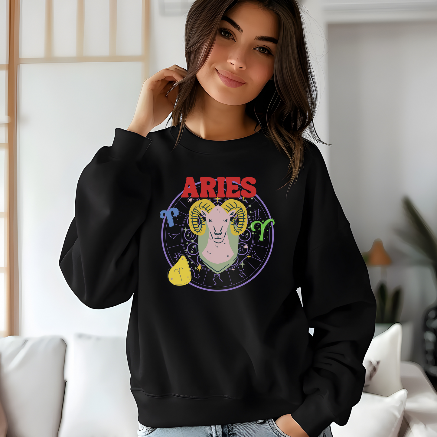 Black Aries sweatshirt featuring colorful ram illustration with zodiac symbols and bold red 'Aries' text.