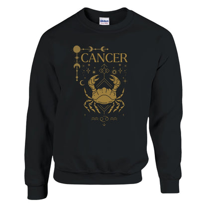 Black sweatshirt featuring a Cancer zodiac design in a brownish-gold color. The central illustration shows a stylized crab with intricate celestial symbols, stars, and decorative accents surrounding it. The word 'Cancer' is displayed above, and the Cancer zodiac symbol appears below, giving the design a mystical and astrological aesthetic.