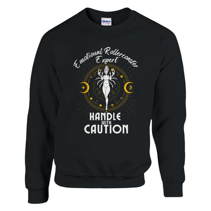 Black cancer zodiac sweatshirt with 'Emotional Rollercoaster Expert' and 'Handle with Caution' text; design features Cancer symbol with celestial elements, showcasing a playful take on Cancer traits.