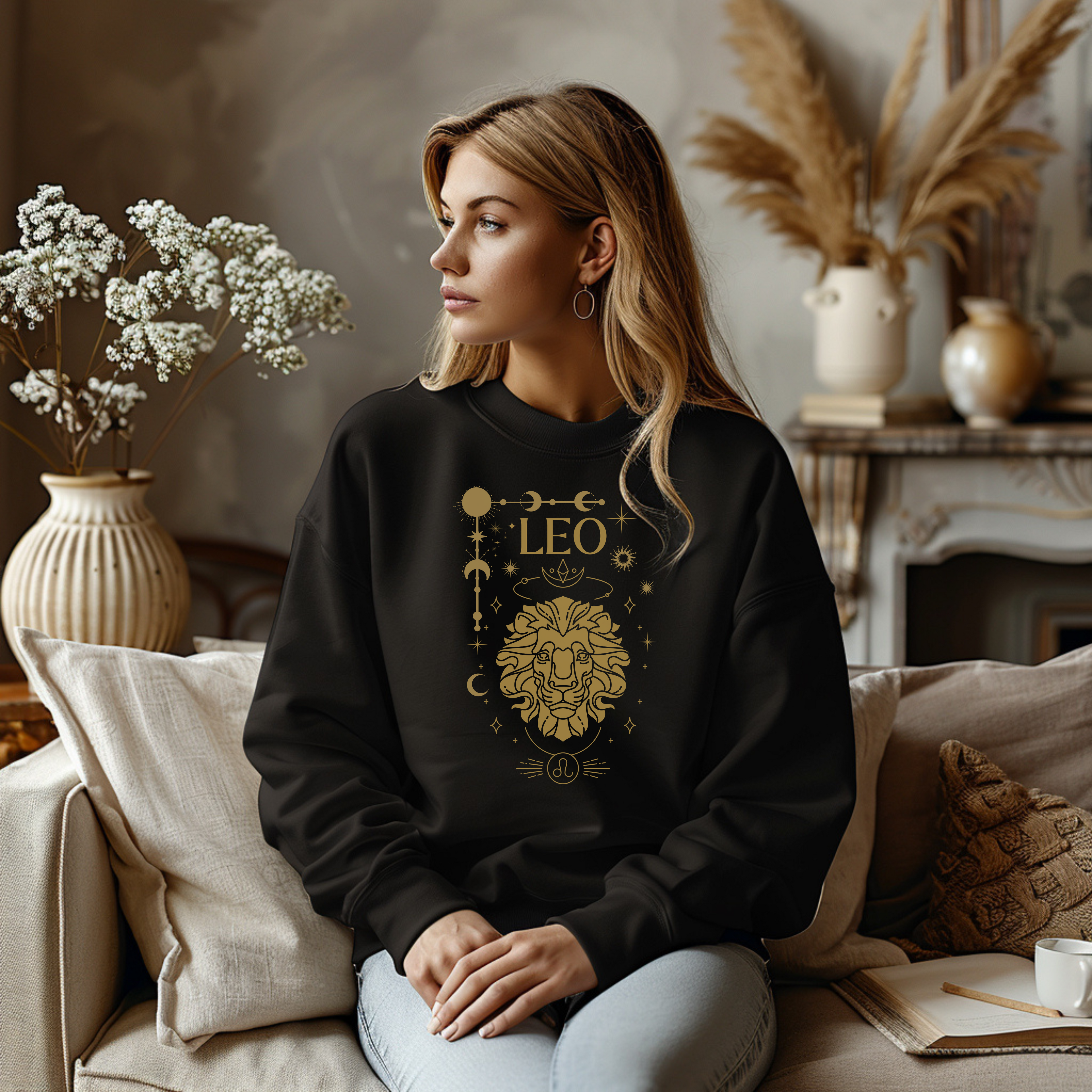 Black Leo sweatshirt with a gold like lion design, featuring celestial symbols and zodiac elements representing Leo's bold personality