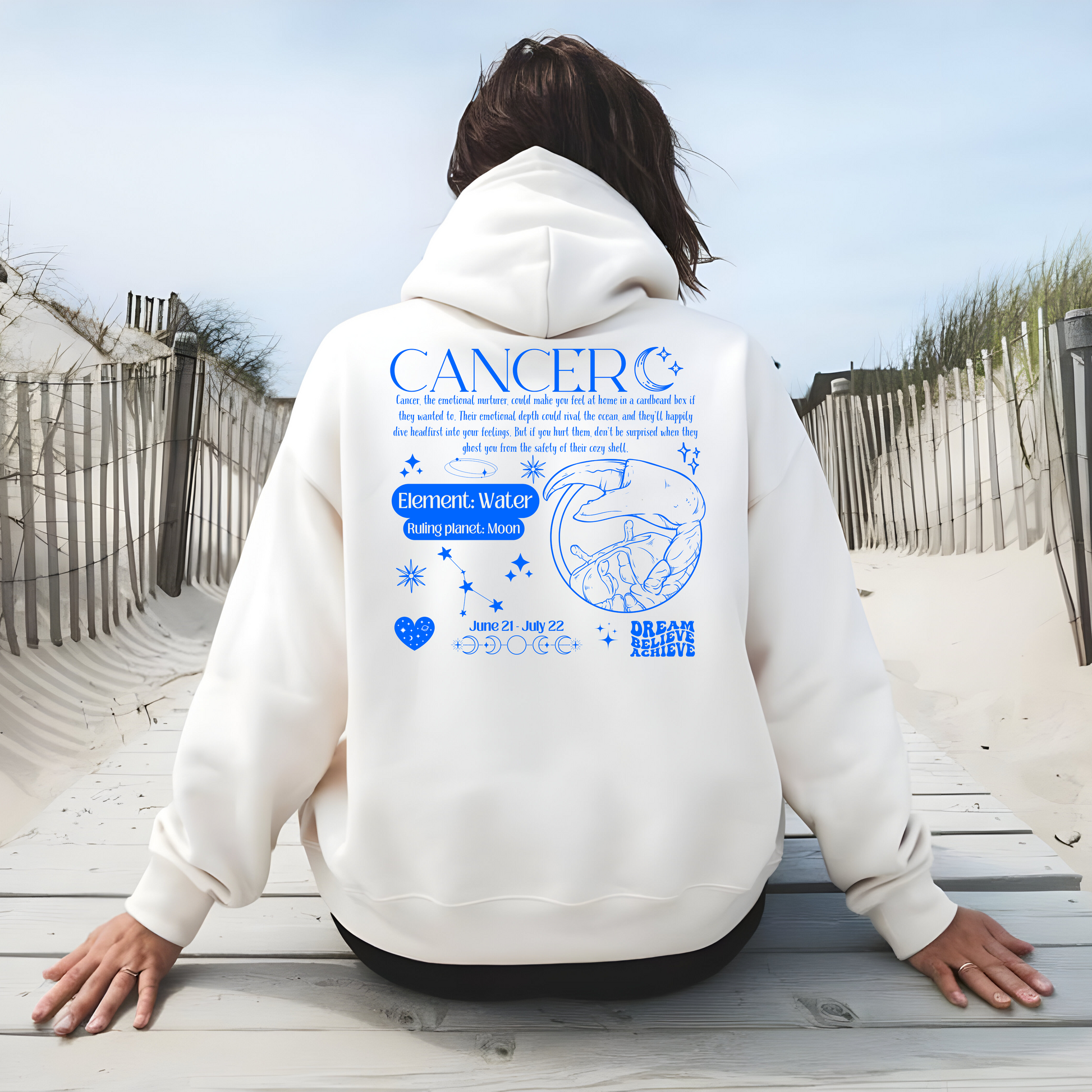 Back of white Cancer hoodie with blue zodiac design, featuring the Cancer symbol, ruling planet Moon, water element, and descriptive traits for Cancer zodiac personality.