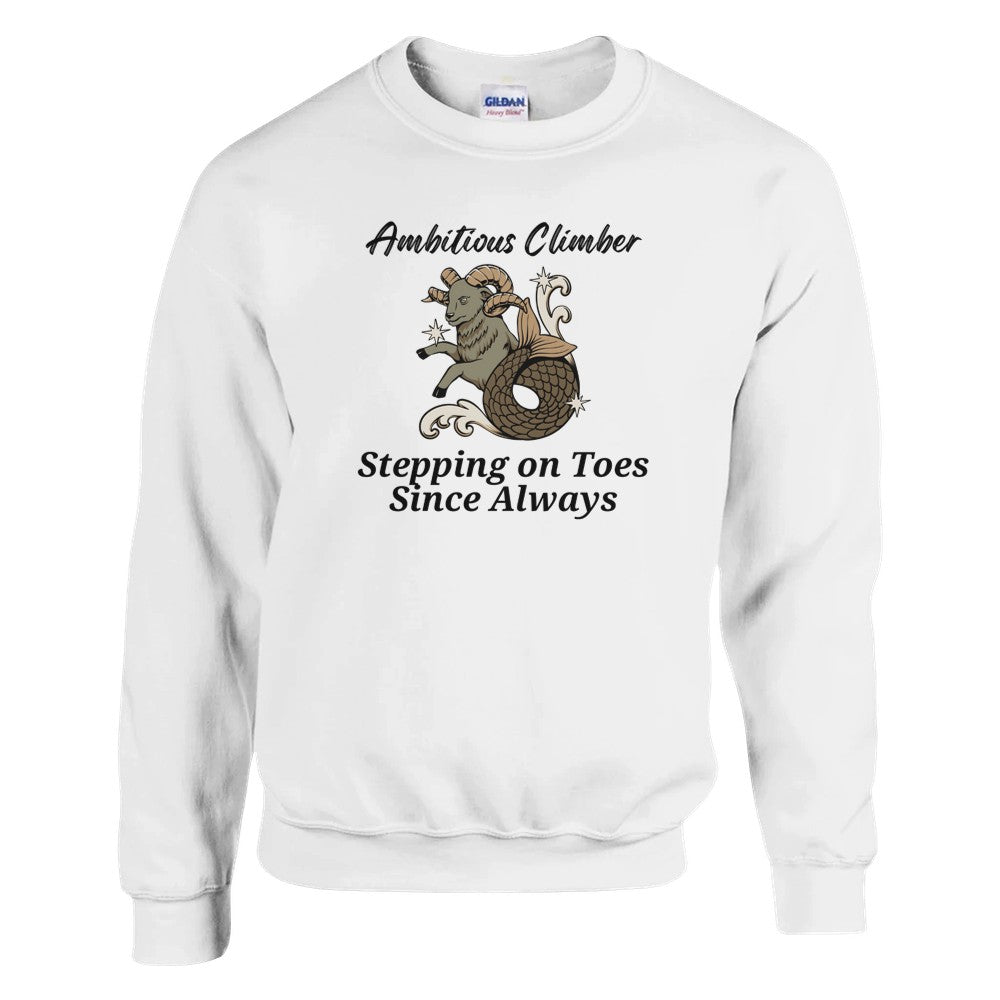 Front of white Capricorn-themed sweatshirt with a playful design featuring a Capricorn goat character and the text 'Ambitious Climber - Stepping on Toes Since Always.