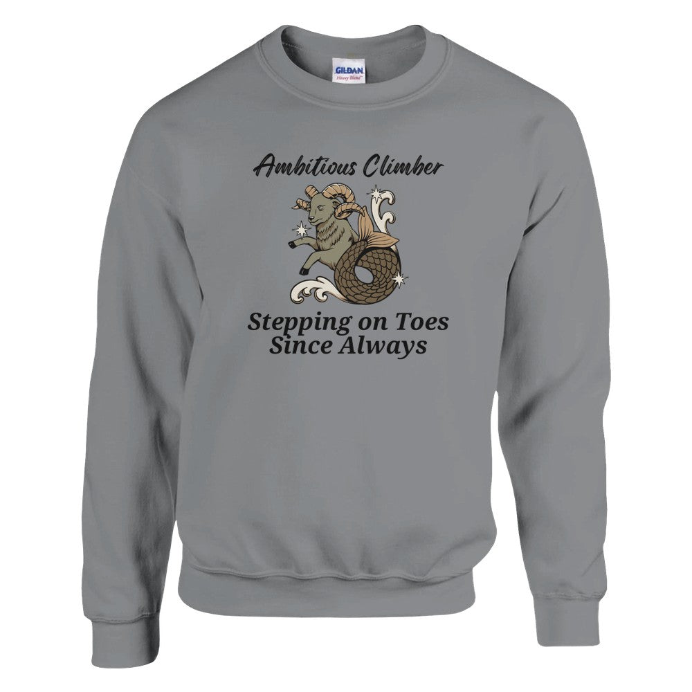 Front of sport grey Capricorn-themed sweatshirt with a playful design featuring a Capricorn goat character and the text 'Ambitious Climber - Stepping on Toes Since Always.