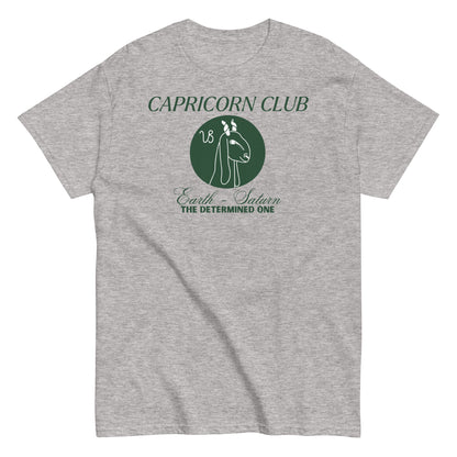 Front of sport grey Capricorn-themed t-shirt with green 'Capricorn Club' text, Capricorn symbol illustration, and phrase 'Earth - Saturn, The Determined One.