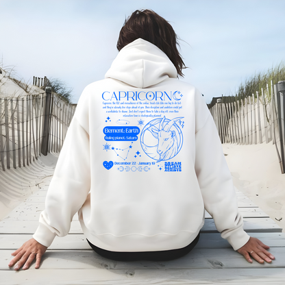 Back of white Capricorn-themed hoodie featuring retro astrology design with Capricorn symbol, element Earth, ruling planet Saturn, and decorative celestial details.