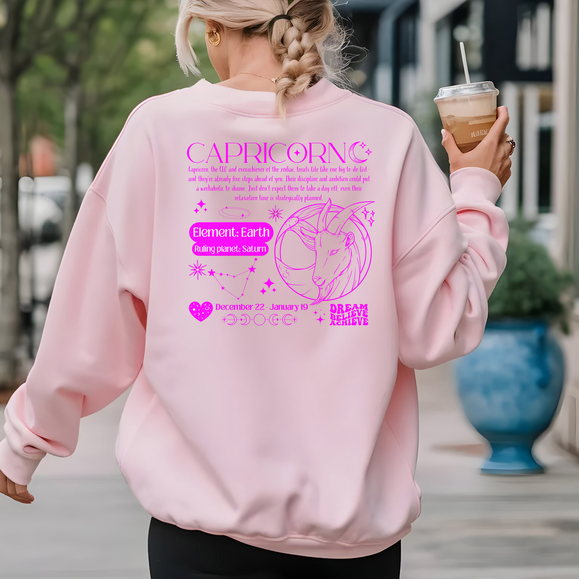 Back of light pink Capricorn-themed sweatshirt with retro astrology design featuring Capricorn symbol, zodiac dates, and celestial details.