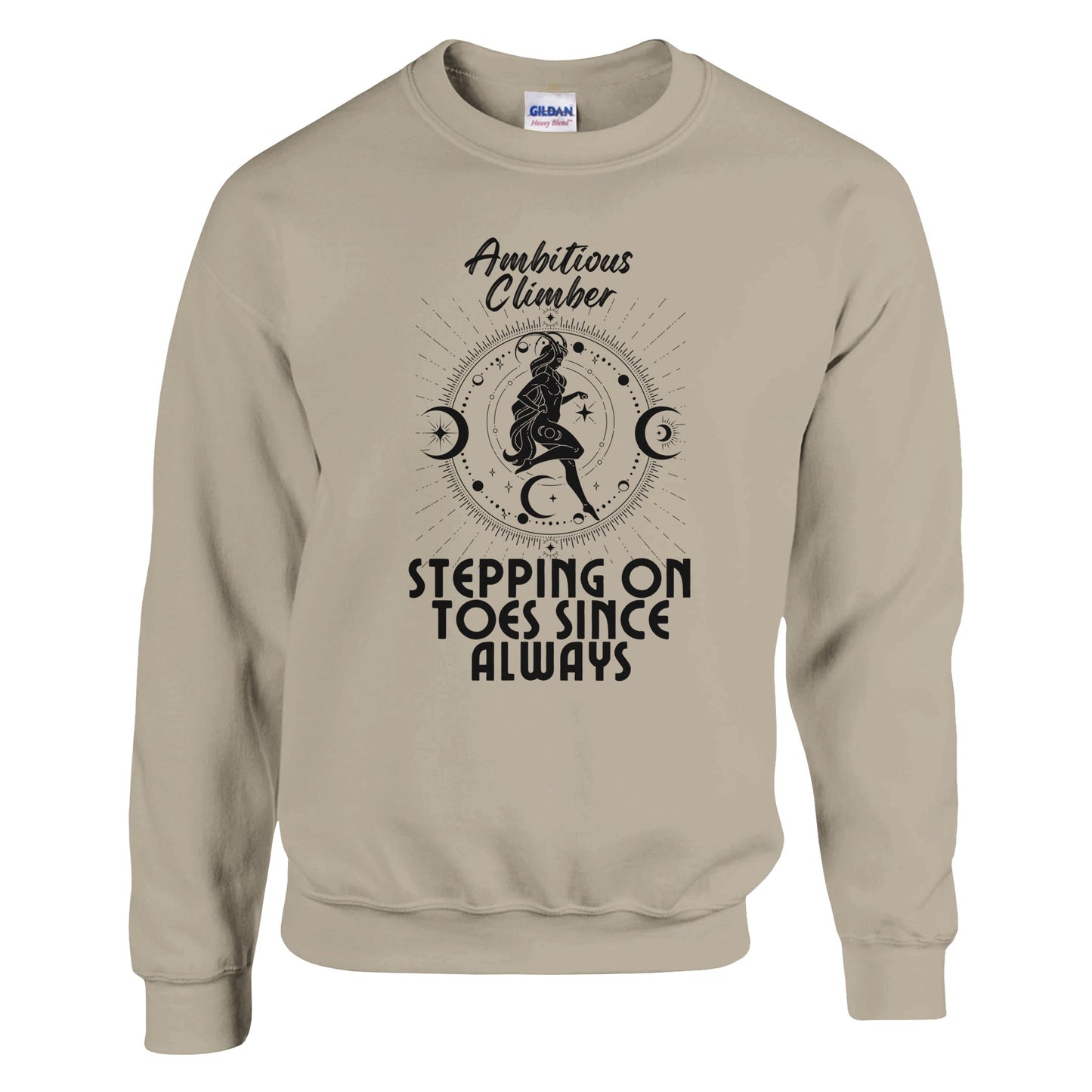 Front of sand Capricorn-themed sweatshirt with retro design, featuring text 'Ambitious Climber' above an illustration of a determined figure, surrounded by celestial symbols, and 'Stepping on Toes Since Always' below.