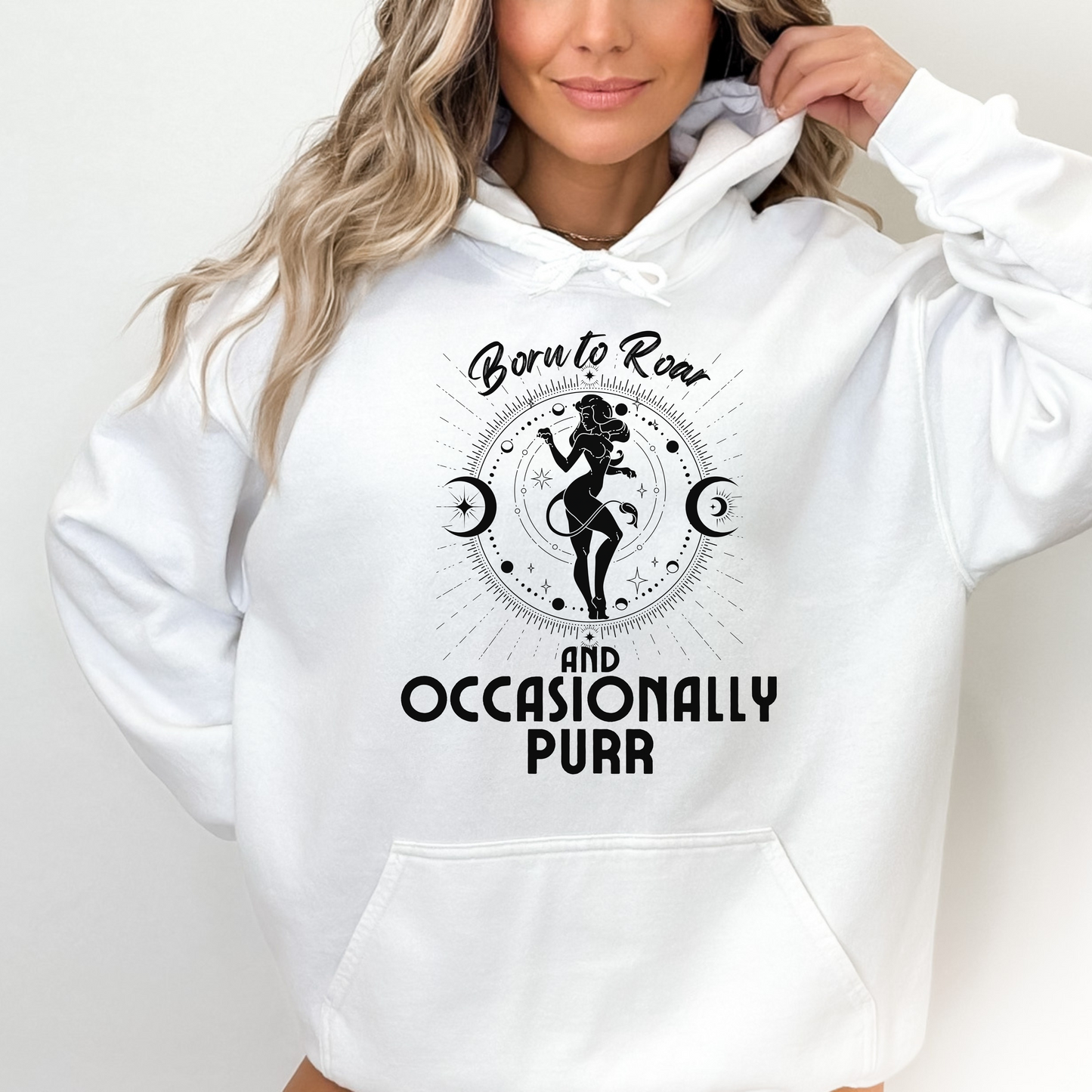 Front of white hoodie with Leo-themed design, featuring an illustration of a character surrounded by celestial elements and text that reads 'Born to Roar and Occasionally Purr.