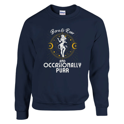 Front of navy blue sweatshirt featuring a Leo-themed design with a celestial motif around a lion figure in white and yellow accents. Text reads 'Born to Roar and Occasionally Purr.