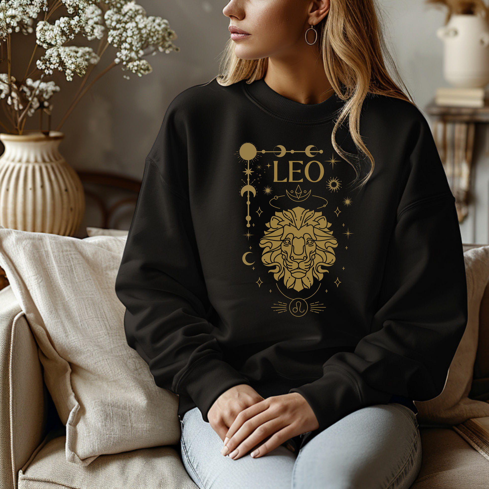 Front of black sweatshirt featuring a Leo-themed glamour design with a stylized brown lion illustration and celestial symbols. Text reads 'Leo' with zodiac symbol.