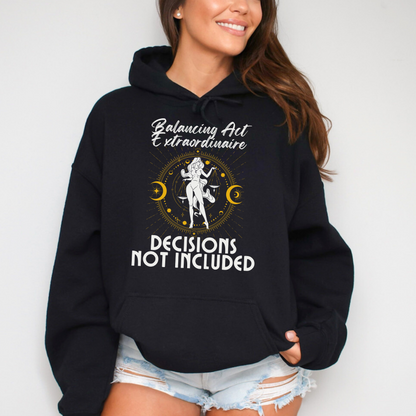 Front of black Libra hoodie with 'Balancing Act Extraordinaire' and 'Decisions Not Included' design featuring scales and celestial symbols.