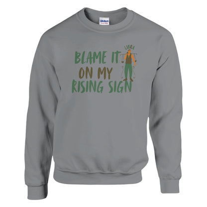 Front of sport grey Libra sweatshirt with 'Blame It on My Rising Sign' text and illustration featuring a balanced scale symbol.