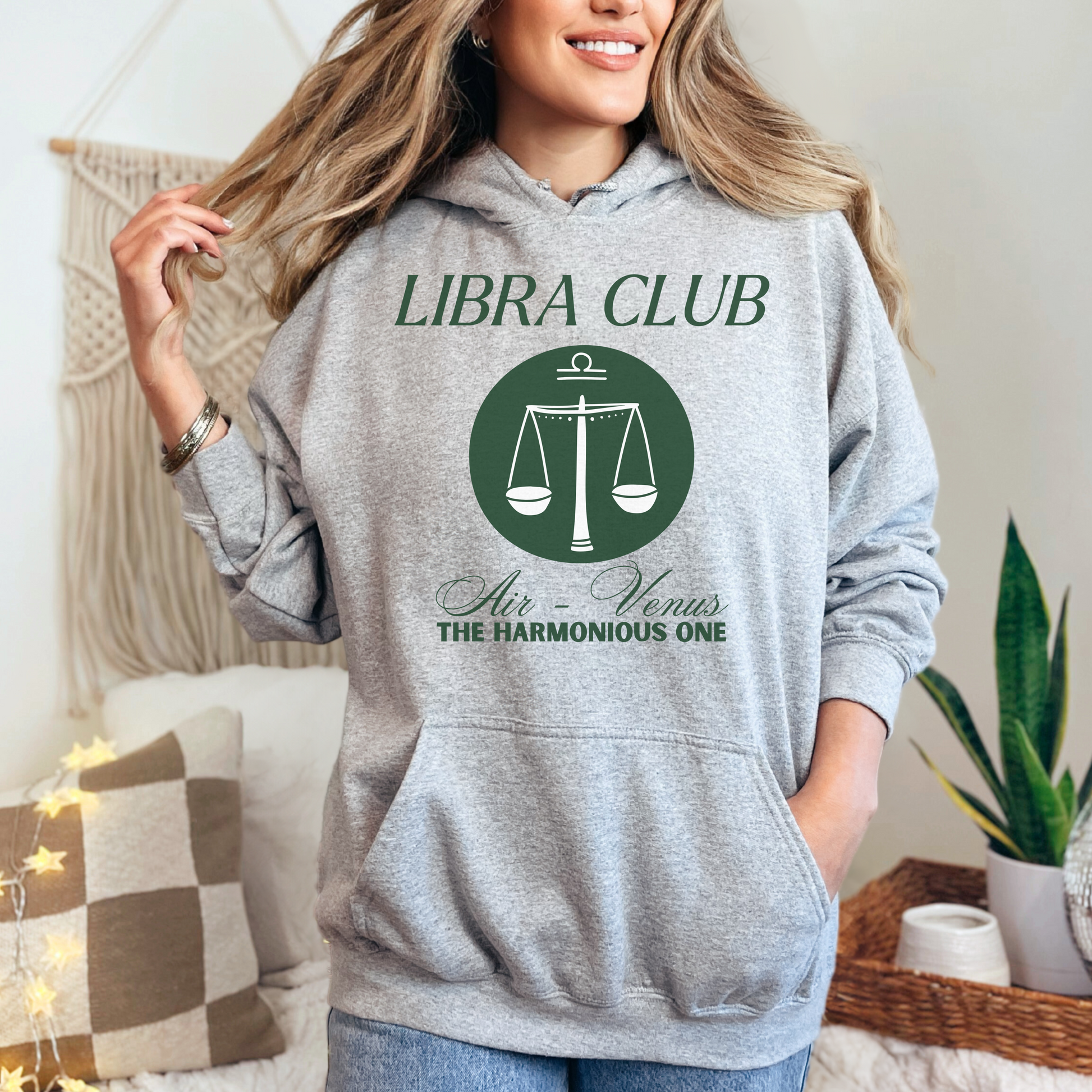 Front of sport grey Libra hoodie with 'Libra Club' design featuring scales, symbolizing air and Venus, labeled 'The Harmonious One.