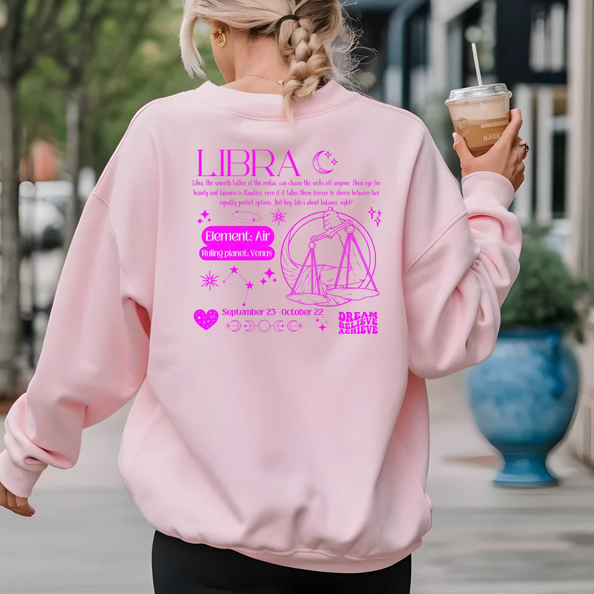 Light pink Libra sweatshirt with retro-style back design featuring Libra scales illustration, zodiac traits, and symbols in dark pink.