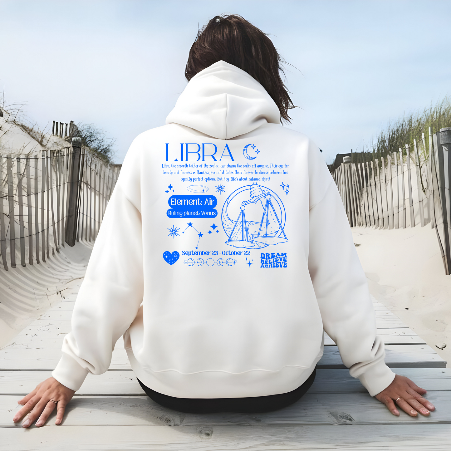 White Libra hoodie with back design featuring scales illustration, zodiac traits, and 'Libra' text in blue retro style.