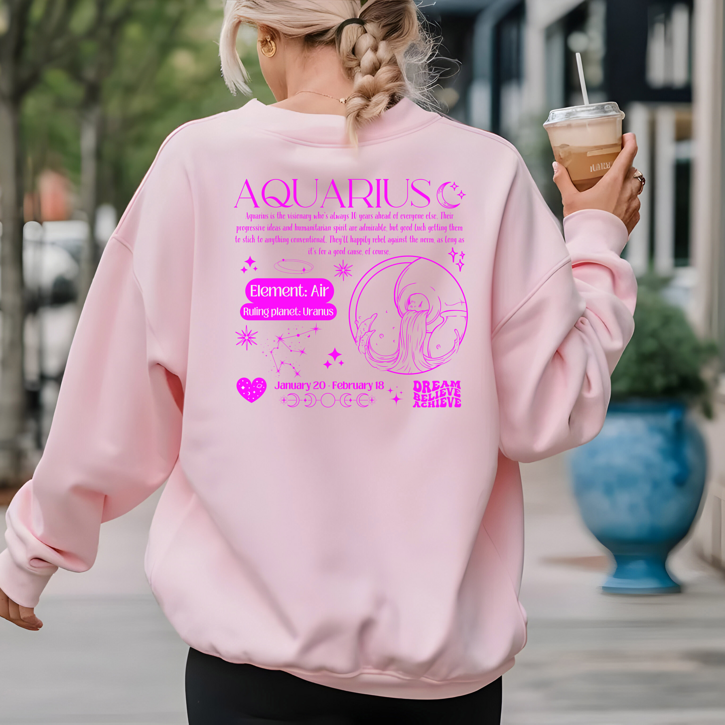 Back of light pink Aquarius sweatshirt with dark pink zodiac design, featuring Aquarius symbol, Air element, Uranus ruling planet, and inspirational text.