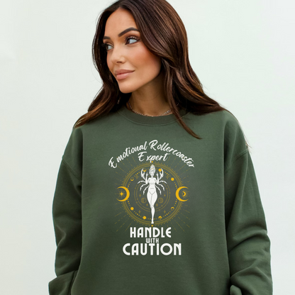 Military green cancer zodiac sweatshirt with 'Emotional Rollercoaster Expert' and 'Handle with Caution' text; design features Cancer symbol with celestial elements, showcasing a playful take on Cancer traits.