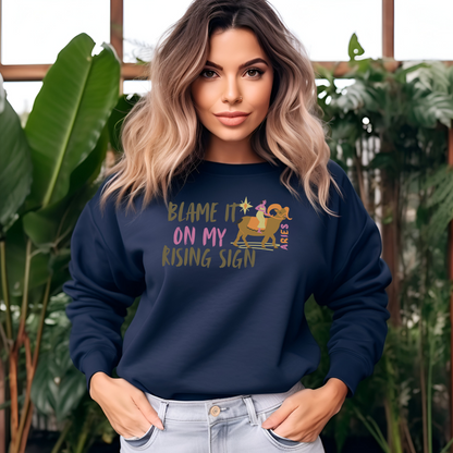 Navy blue sweatshirt with 'Blame It On My Rising Sign' text and colorful Aries design.