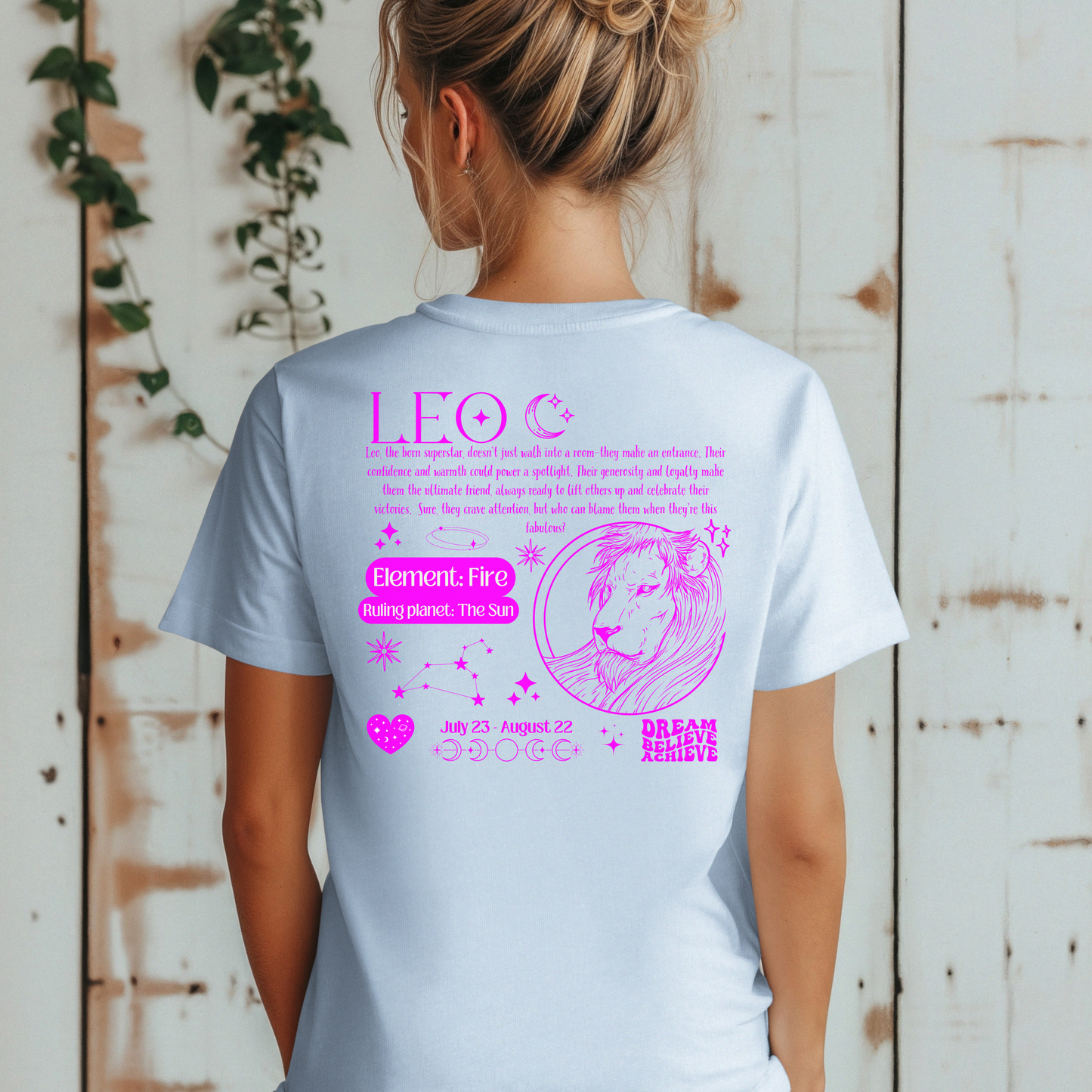 Back of light blue retro-style Leo t-shirt with pink lion illustration, zodiac details, and Leo personality traits