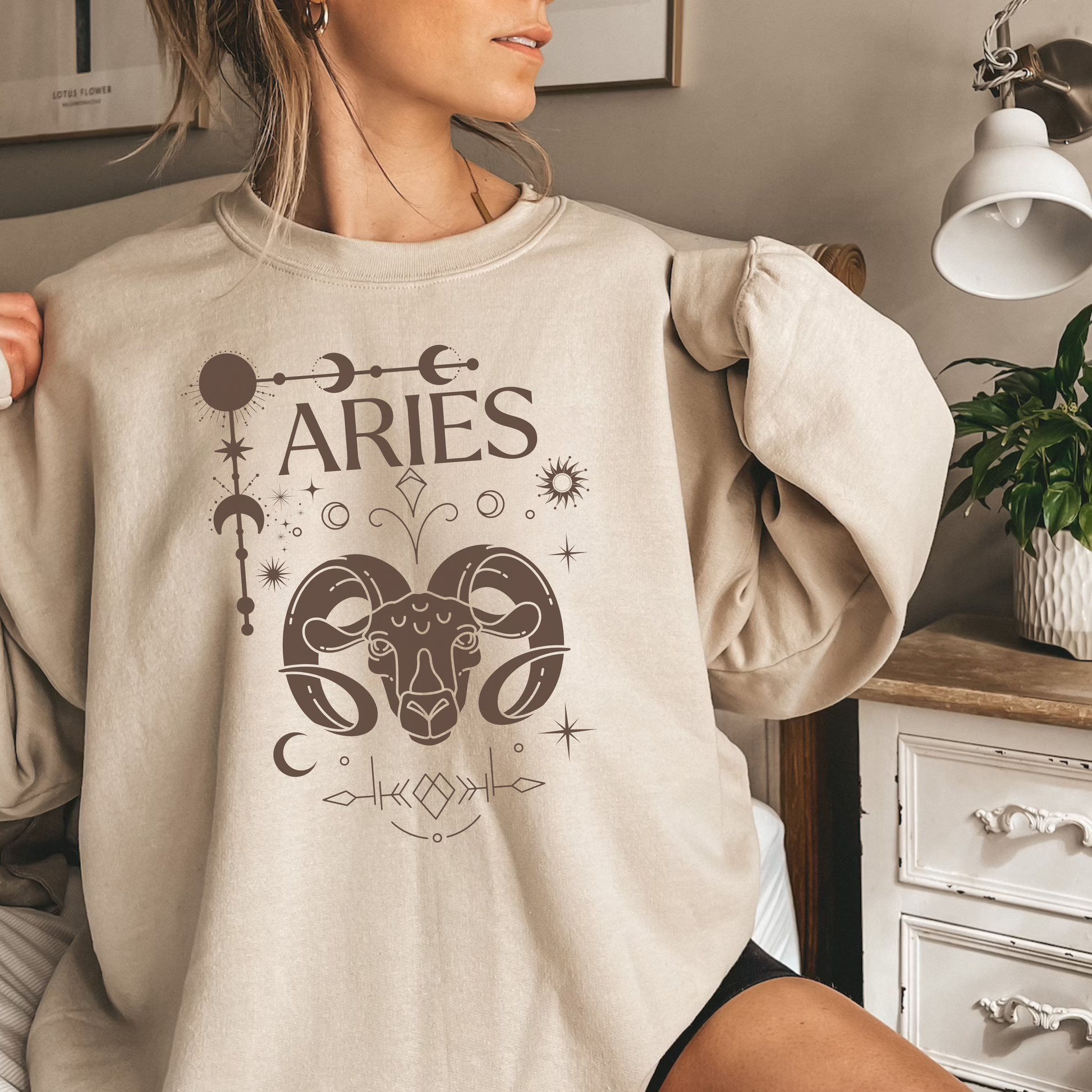 Sand Aries sweatshirt with brown Aries symbol, zodiac signs, and celestial details.