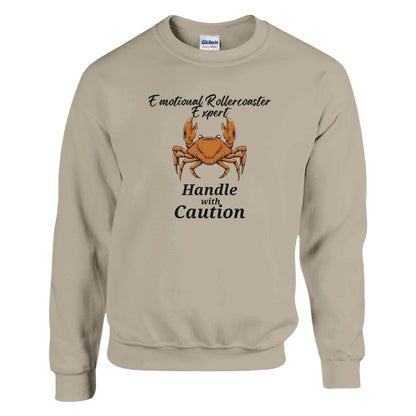 Front of sand Cancer-themed sweatshirt with crab illustration and 'Emotional Rollercoaster Expert - Handle with Caution' text.