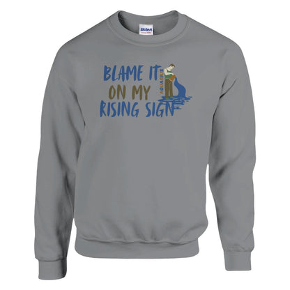 Sport grey Aquarius sweatshirt with 'Blame It On My Rising Sign' text and colorful Aquarius water-bearer illustration in blue and brown tones.