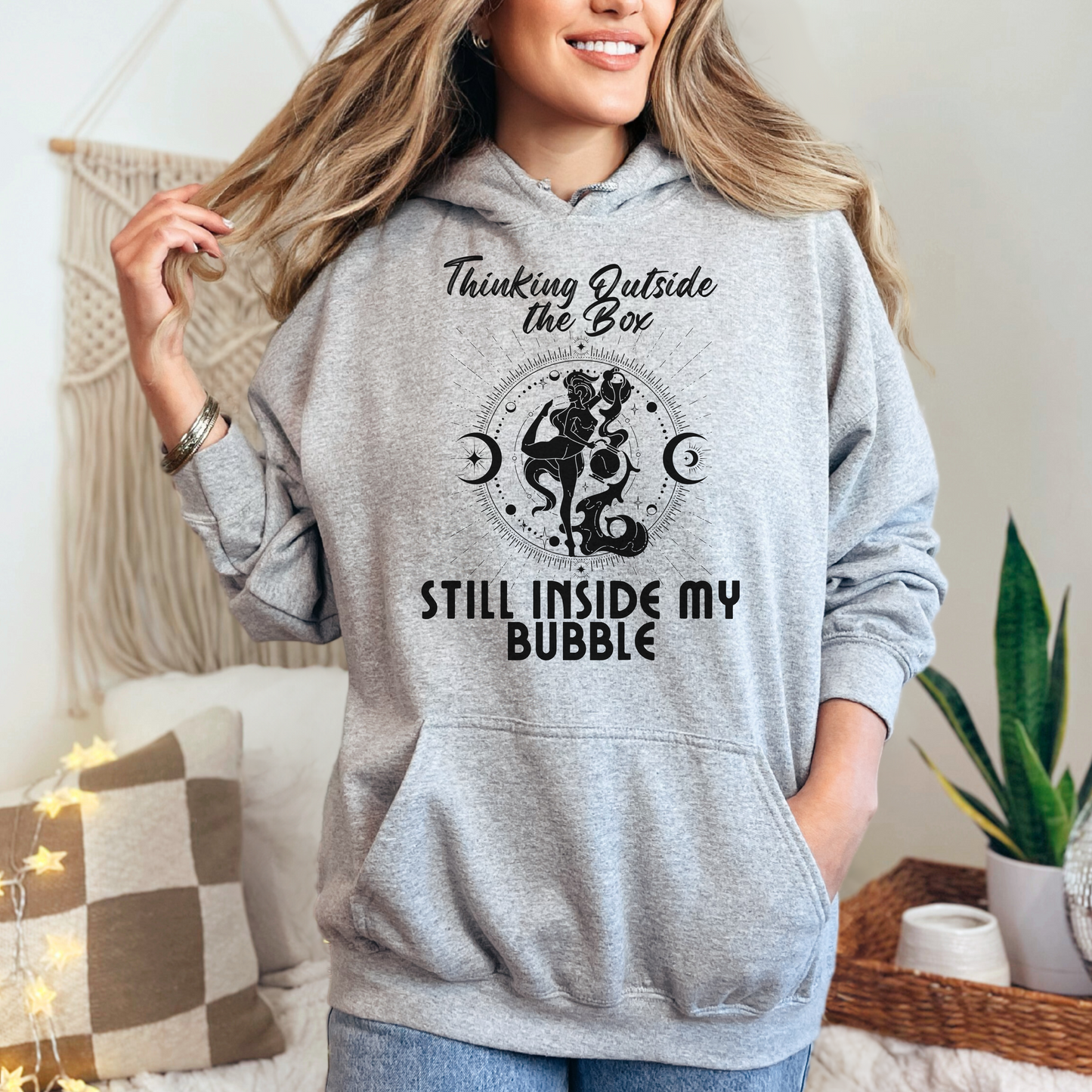 Sport grey Aquarius hoodie featuring 'Thinking Outside the Box, Still Inside My Bubble' text with retro-style Aquarius water-bearer illustration in black colour.