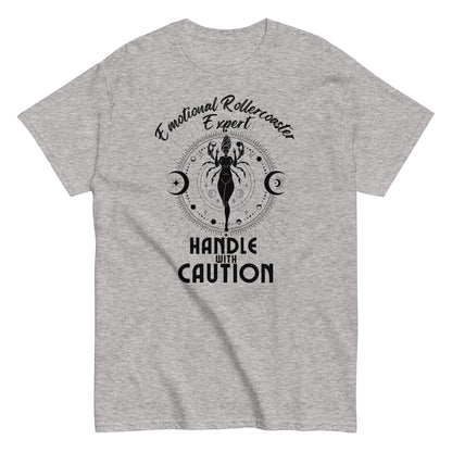 Sport grey t-shirt featuring a Cancer zodiac-themed design with the phrase 'Emotional Rollercoaster Expert' at the top and 'Handle With Caution' at the bottom. The central illustration displays a stylized figure in a mystical design surrounded by celestial symbols, including moons, against a radiant, detailed backdrop in black.