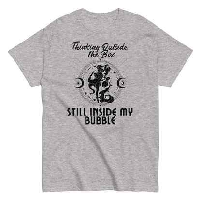 Sport grey t-shirt with a bold black graphic featuring the phrase 'Thinking Outside the Box, Still Inside My Bubble.' Design includes an intricate retro-inspired illustration with celestial symbols.