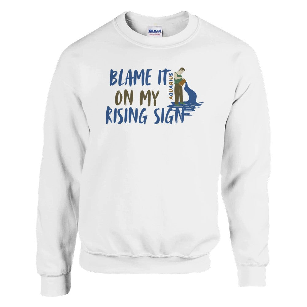 White Aquarius sweatshirt with 'Blame It On My Rising Sign' text and colorful Aquarius water-bearer illustration in blue and brown tones.