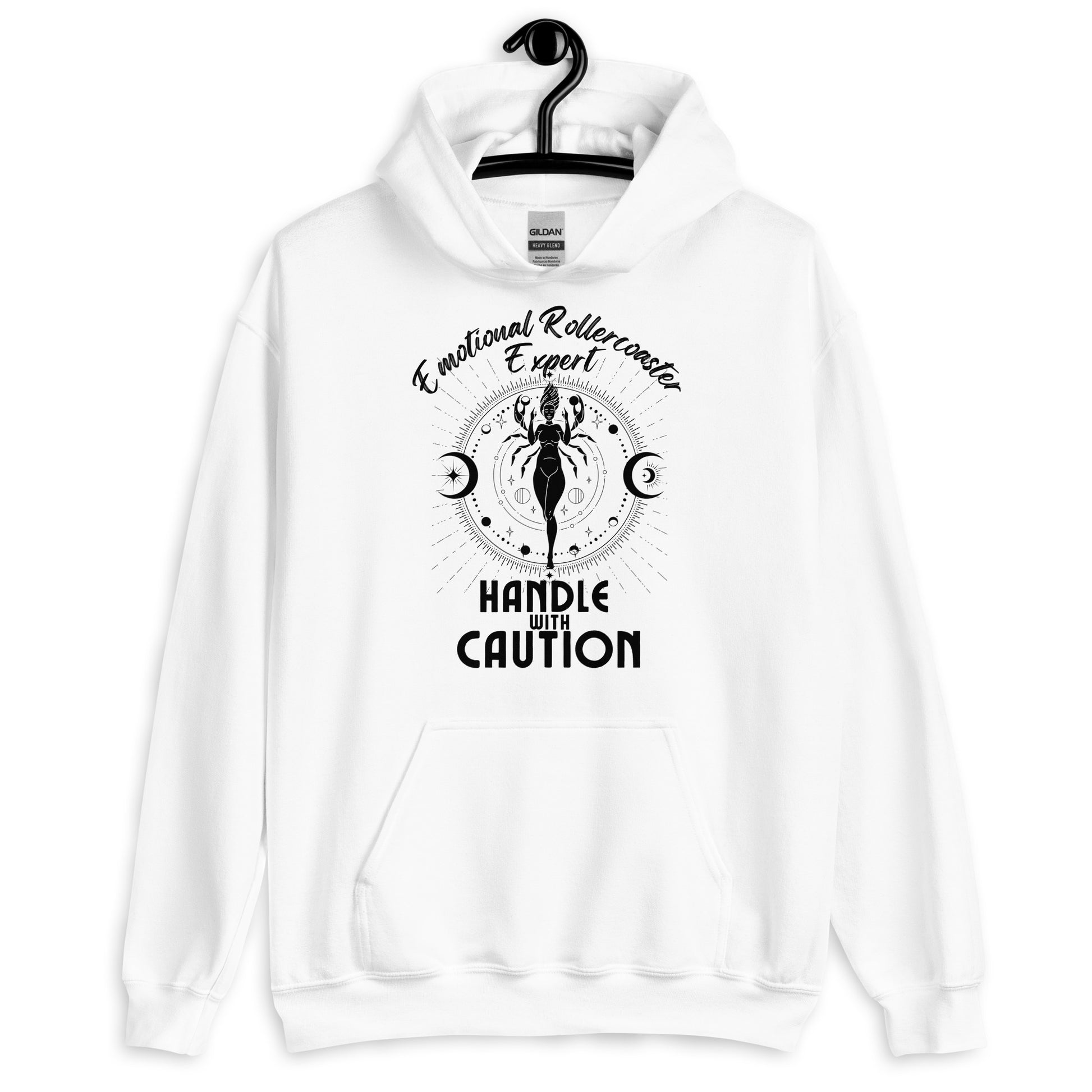 White hoodie featuring a Cancer zodiac-themed design with the phrase 'Emotional Rollercoaster Expert' at the top and 'Handle With Caution' at the bottom. The central illustration depicts a stylized figure surrounded by celestial symbols, including moons and stars, with a mystical, radiant backdrop in black accents.