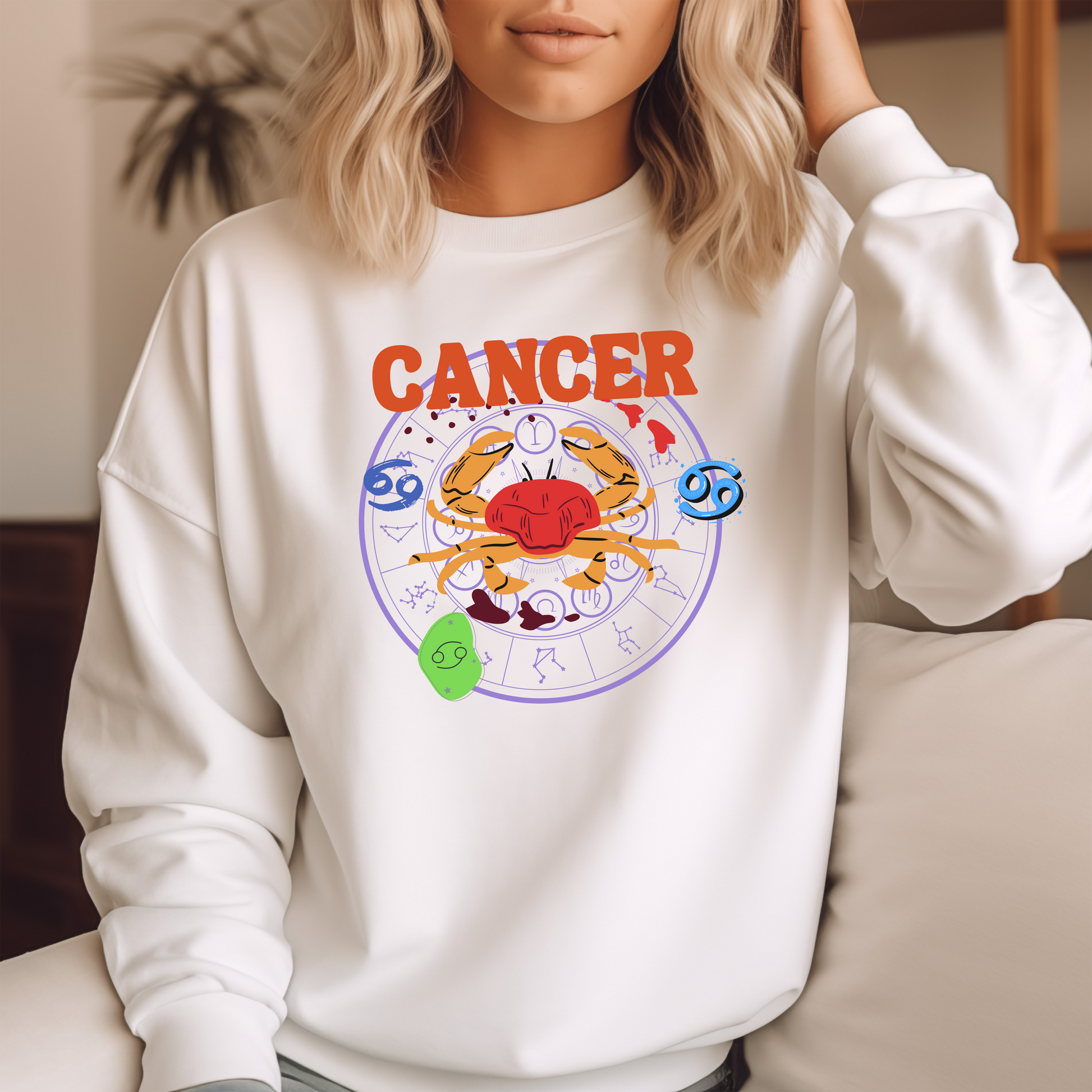 Front of white Cancer-themed sweatshirt with a colorful crab illustration and zodiac symbols in retro style.