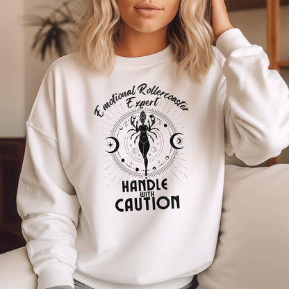 White cancer zodiac sweatshirt with 'Emotional Rollercoaster Expert' and 'Handle with Caution' text; design features Cancer symbol with celestial elements, showcasing a playful take on Cancer traits.