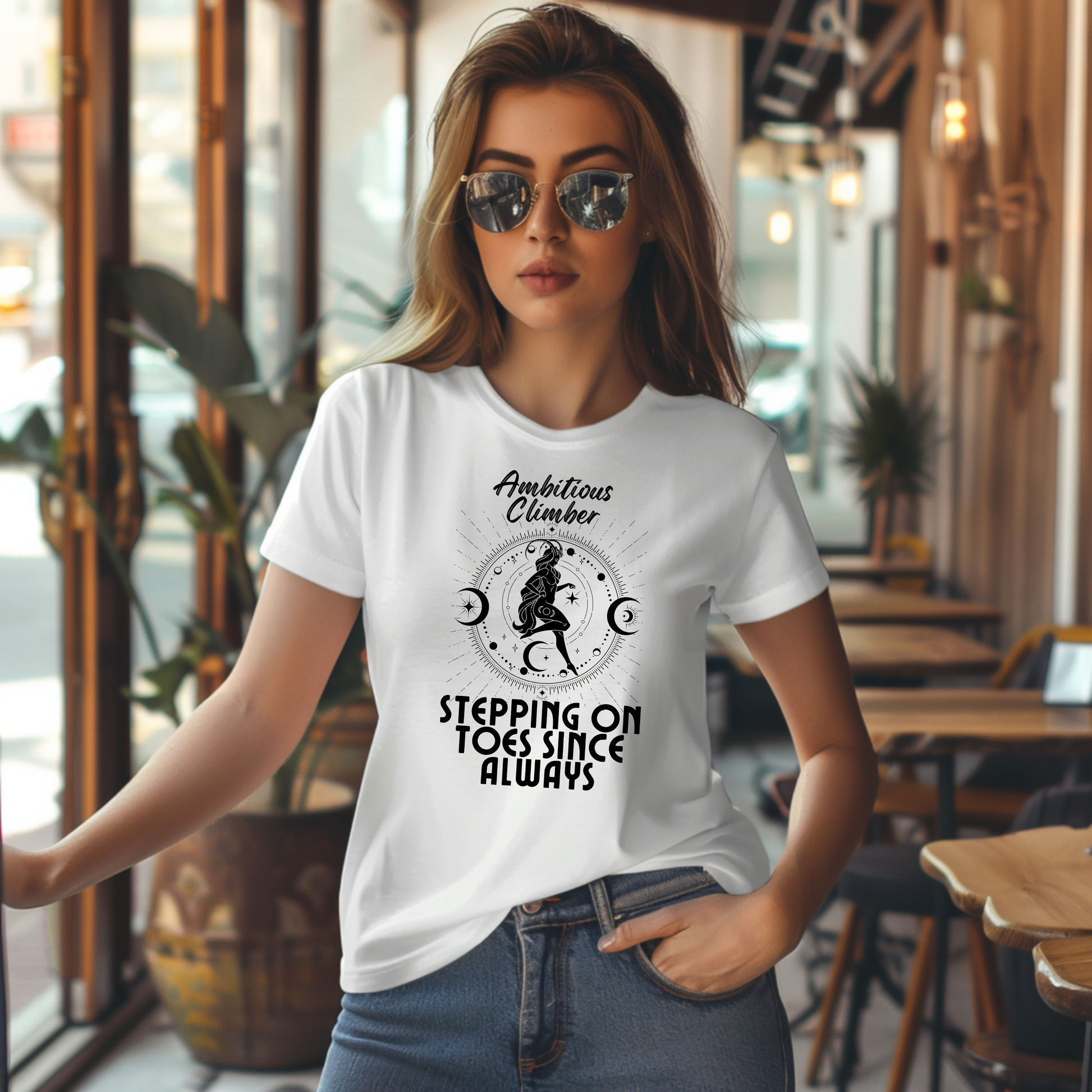 Front of white Capricorn-themed t-shirt with 'Ambitious Climber' text, illustration of Capricorn symbol, and phrase 'Stepping on Toes Since Always.