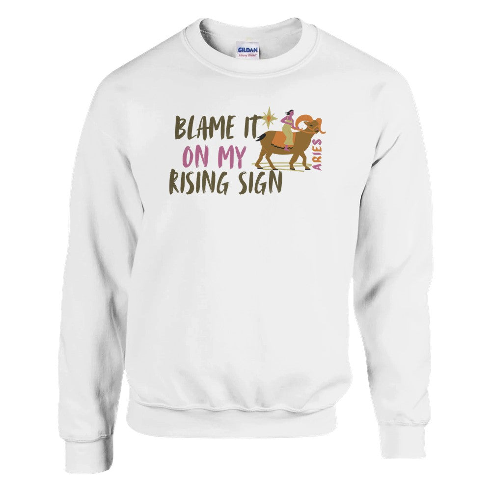 White sweatshirt with 'Blame It On My Rising Sign' text and colorful Aries design.